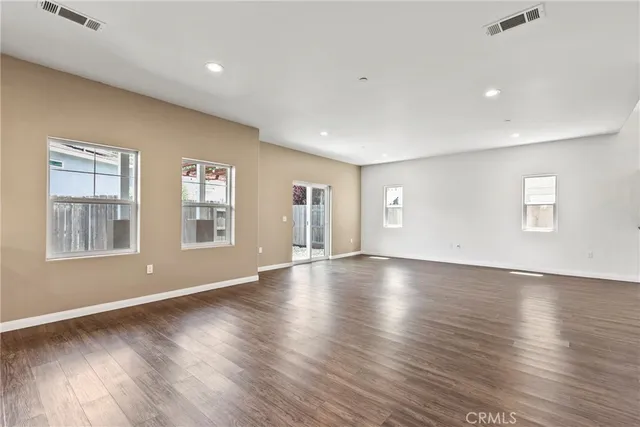 a view of an entryway with wooden floor and door
