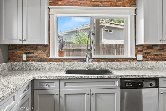 a spacious bathroom with a granite countertop double vanity and a mirror