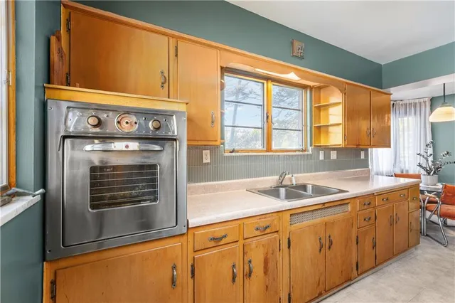 a kitchen with stainless steel appliances granite countertop a sink and cabinets