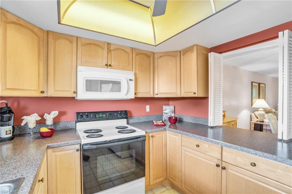5419 Rattlesnake Hamm Road, Unit 304F Naples, FL 34113 - Photo 5 of 15 NICELY APPOINTED KITCHEN WITH NUMEROUS CABINETS..
