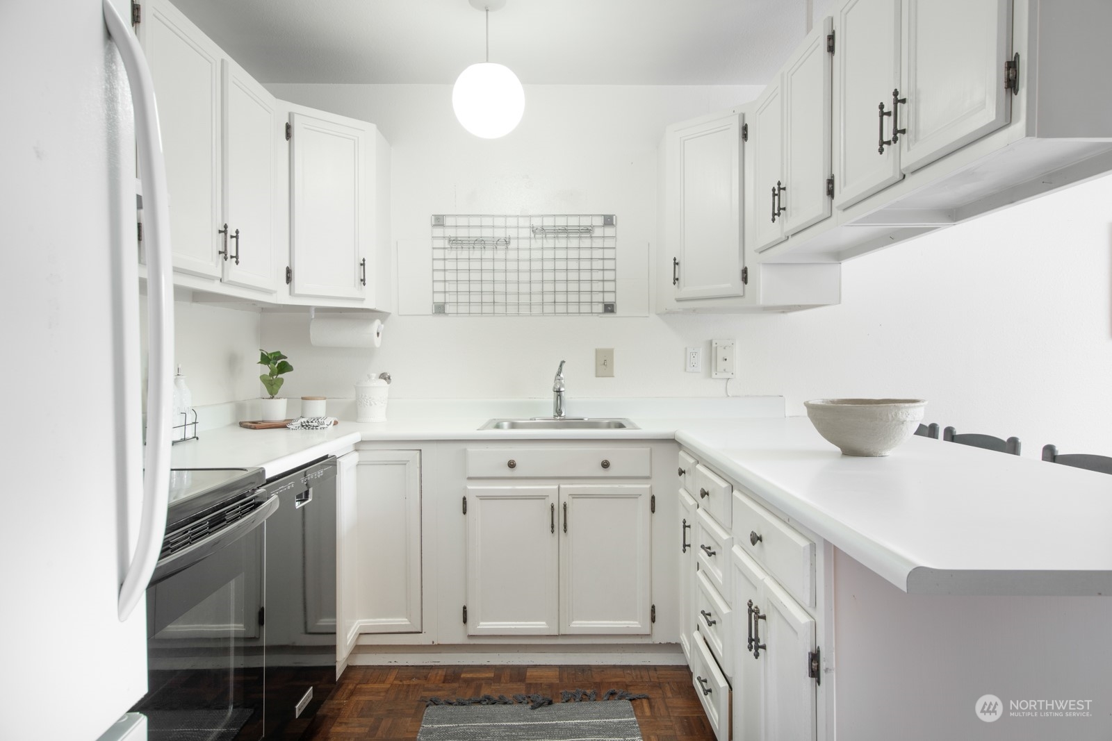6467 Sand Point Way Northeast Seattle, WA 98115 - Photo 11 of 29 a kitchen with white cabinets and sink