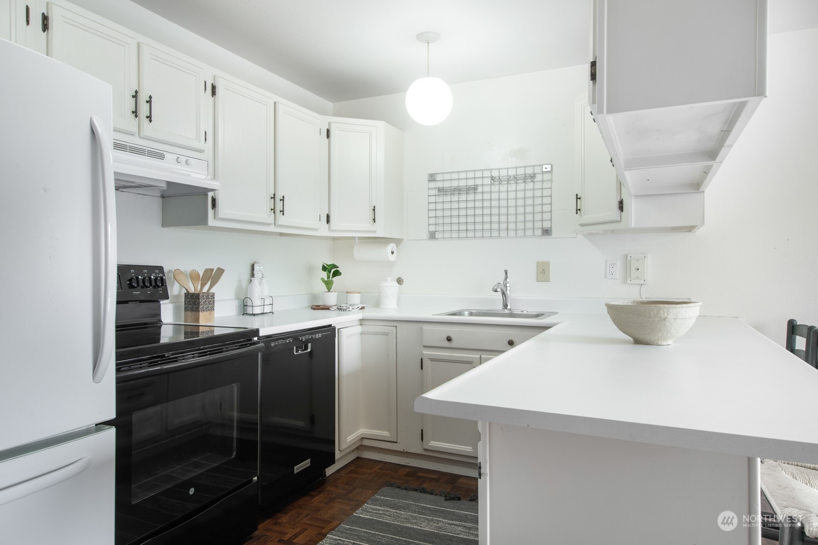 6467 Sand Point Way Northeast Seattle, WA 98115 - Photo 12 of 29 a kitchen with a sink stove and cabinets