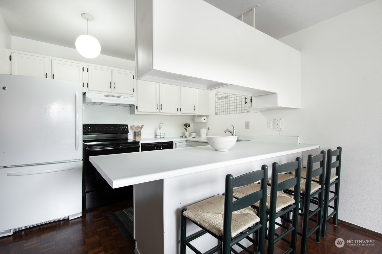 6467 Sand Point Way Northeast Seattle, WA 98115 - Photo 14 of 29 a kitchen with a dining table chairs and cabinets