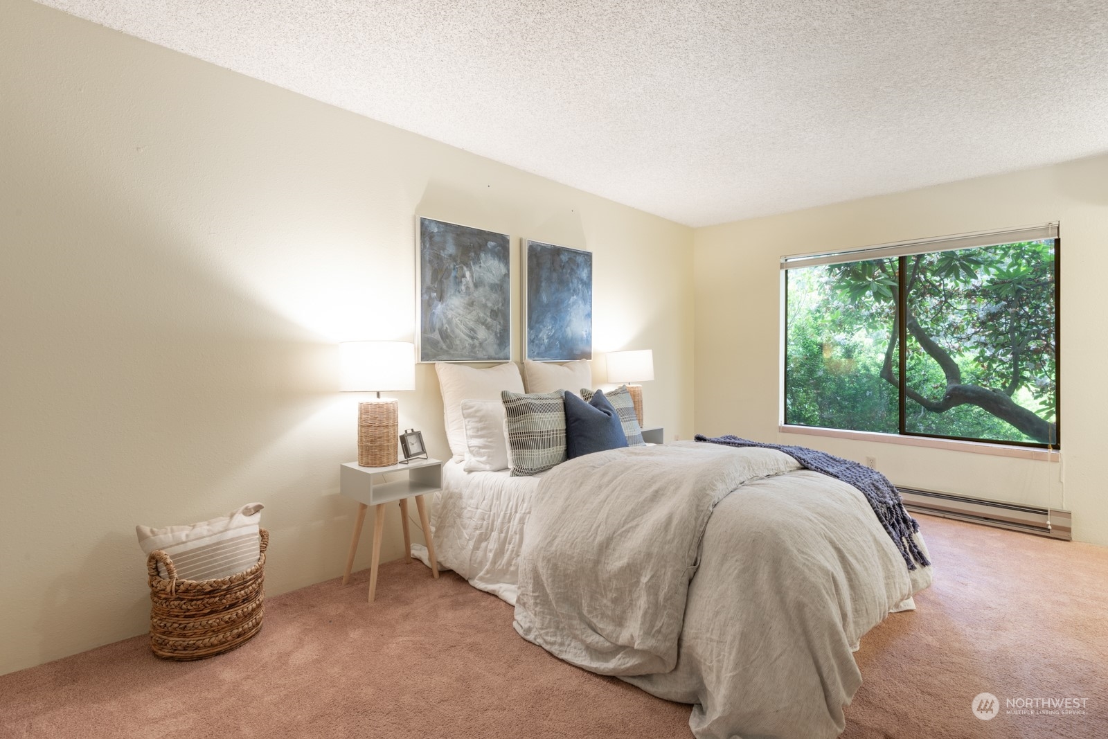 6467 Sand Point Way Northeast Seattle, WA 98115 - Photo 17 of 29 a bed sitting in a spacious bedroom next to a window