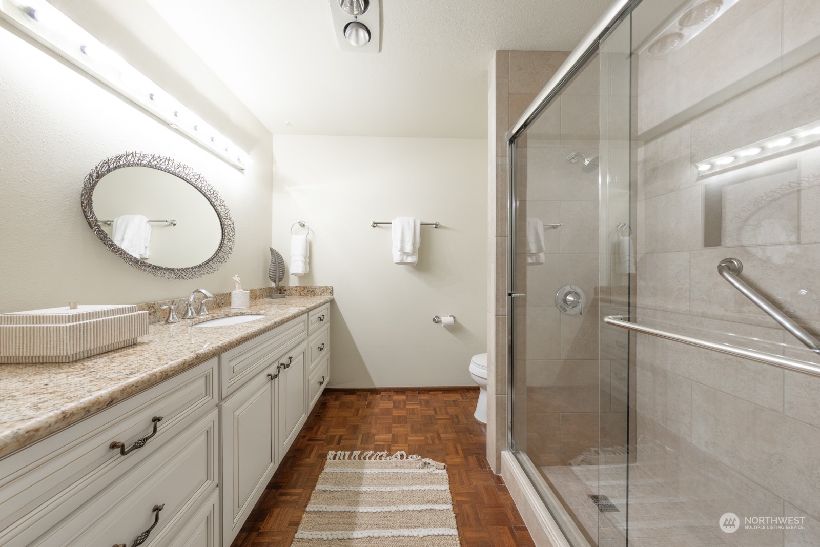 6467 Sand Point Way Northeast Seattle, WA 98115 - Photo 19 of 29 a bathroom with a granite countertop sink mirror and shower