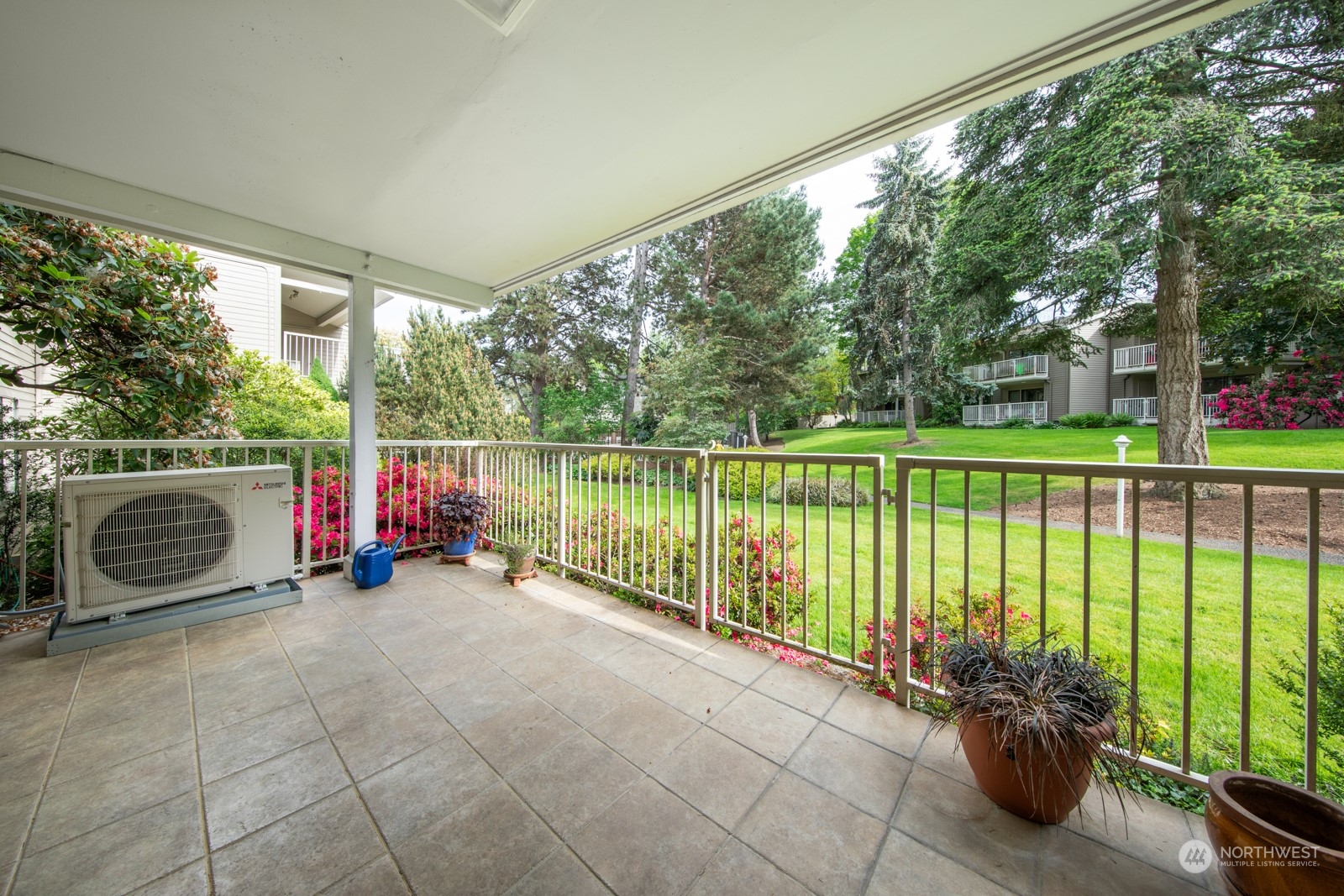 6467 Sand Point Way Northeast Seattle, WA 98115 - Photo 21 of 29 a view of a deck with a floor to ceiling window and a table