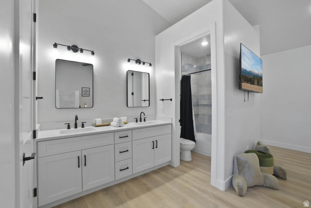 4346 Canterbury Road Hurricane, UT 84737 - Photo 29 of 37 Bathroom featuring double vanity, light wood-style floors, and shower / bath combination with curtain