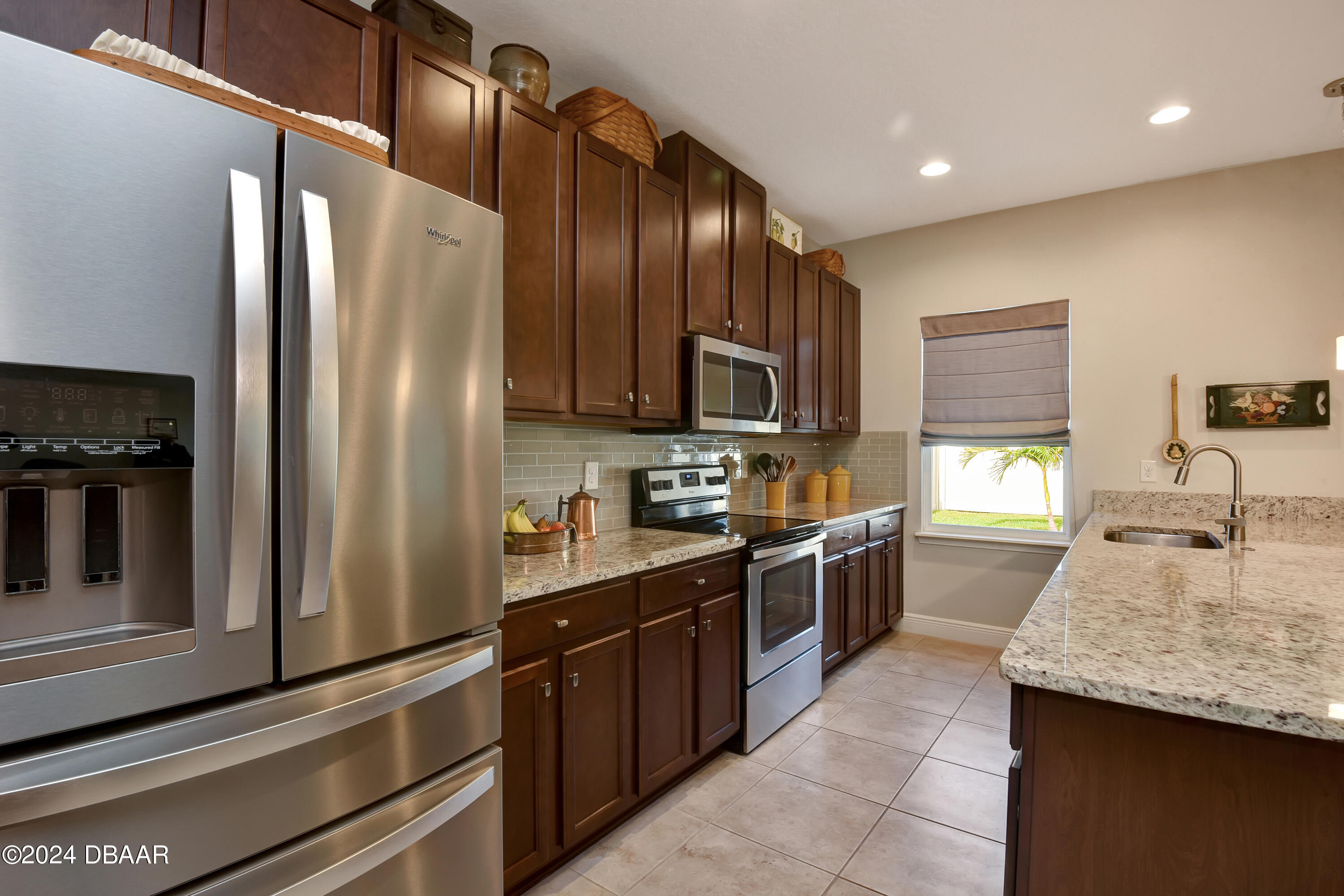 5430 Estero Loop Port Orange, FL 32128 - Photo 12 of 66 a kitchen with granite countertop stainless steel appliances cabinets a sink and a counter top space