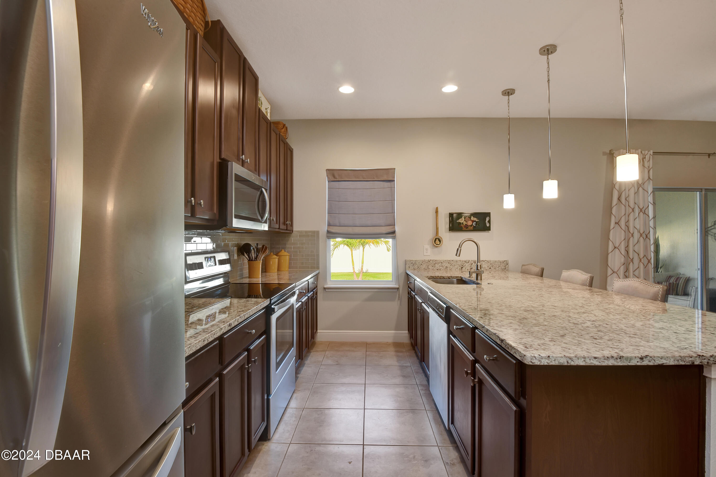 5430 Estero Loop Port Orange, FL 32128 - Photo 13 of 66 a kitchen with granite countertop a sink and cabinets