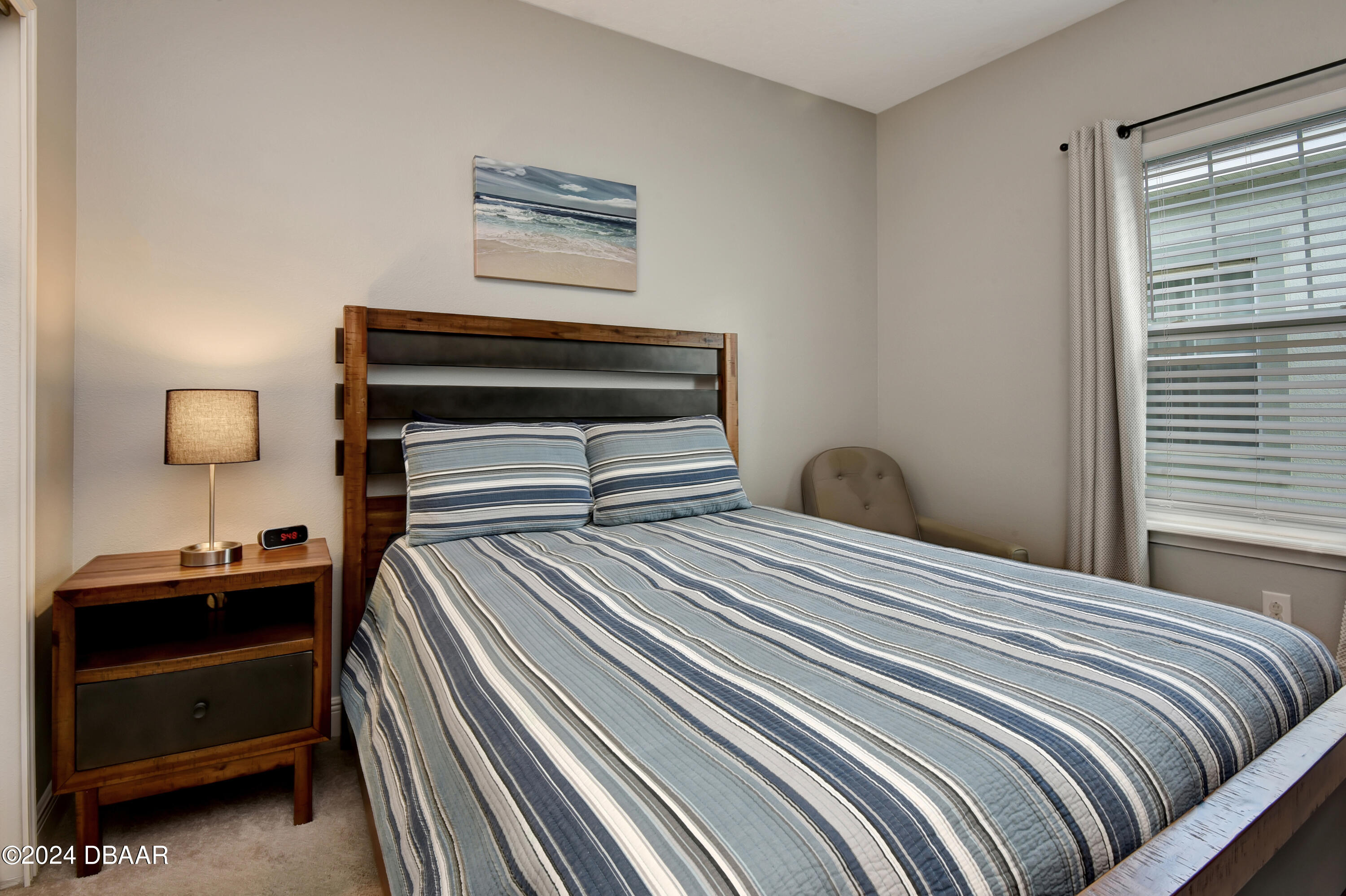 5430 Estero Loop Port Orange, FL 32128 - Photo 31 of 66 a bedroom with a bed and a lamp on dresser