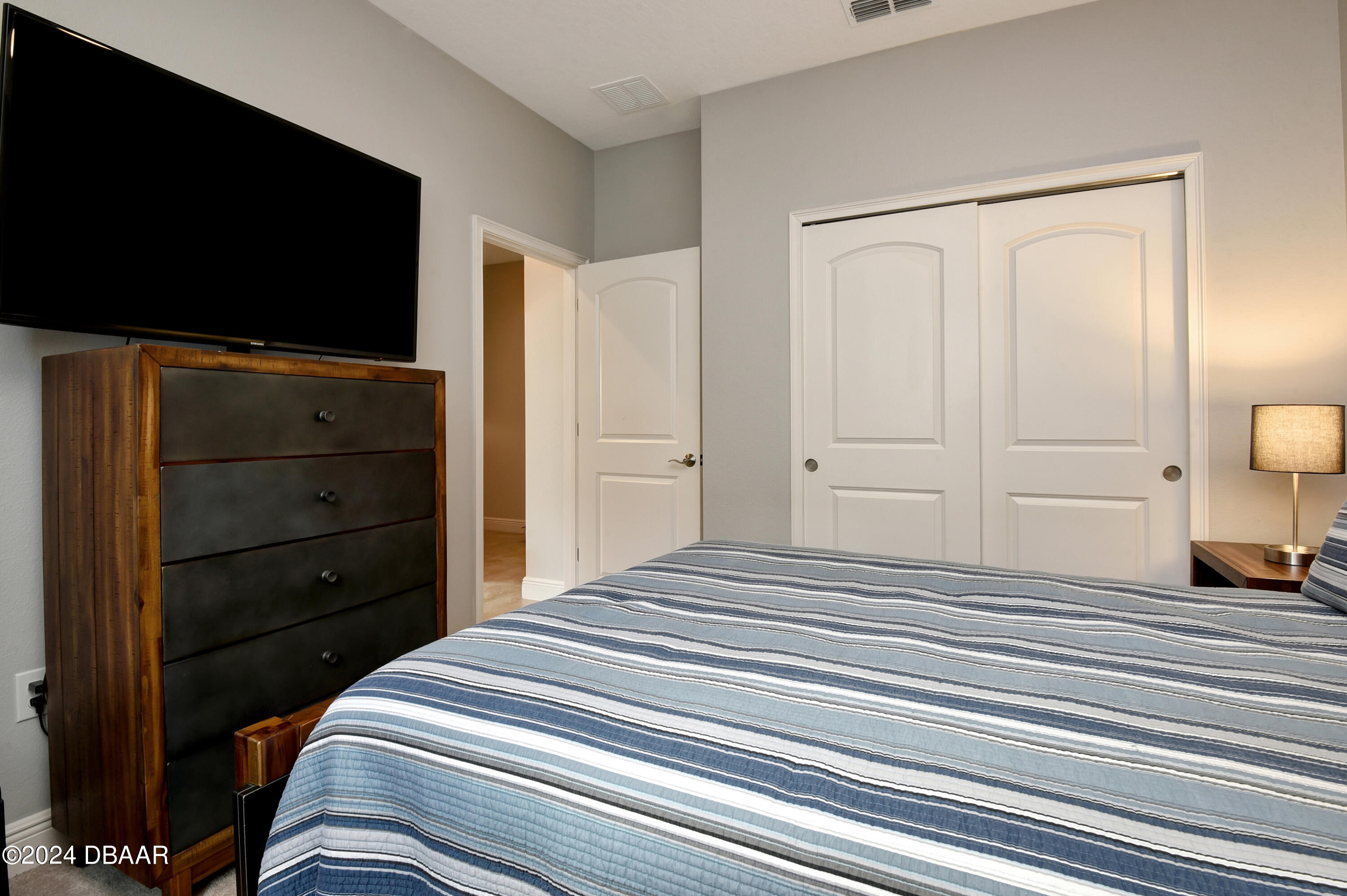 5430 Estero Loop Port Orange, FL 32128 - Photo 33 of 66 a bedroom with a bed and a flat screen tv