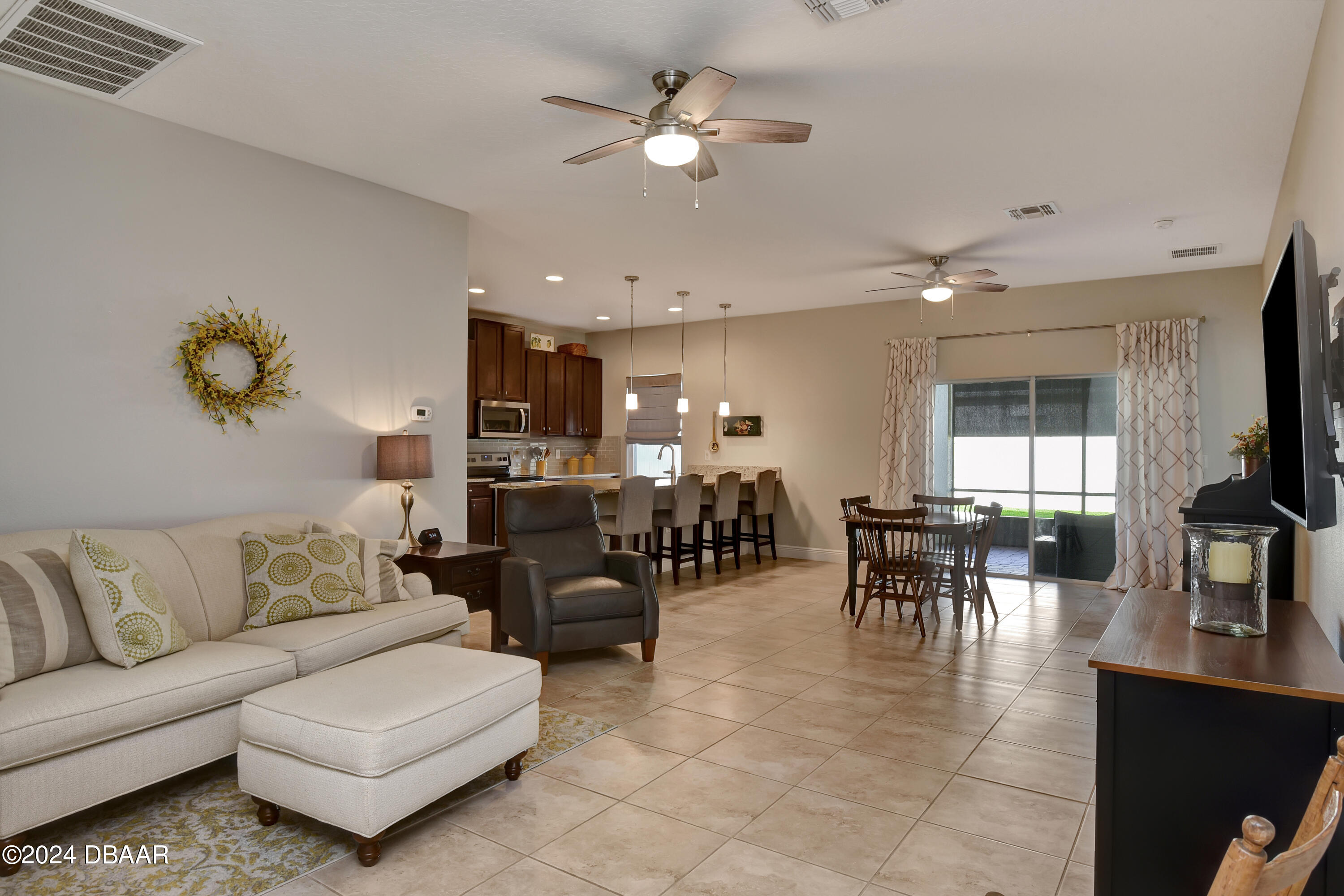 5430 Estero Loop Port Orange, FL 32128 - Photo 4 of 66 a living room with furniture kitchen view and a chandelier