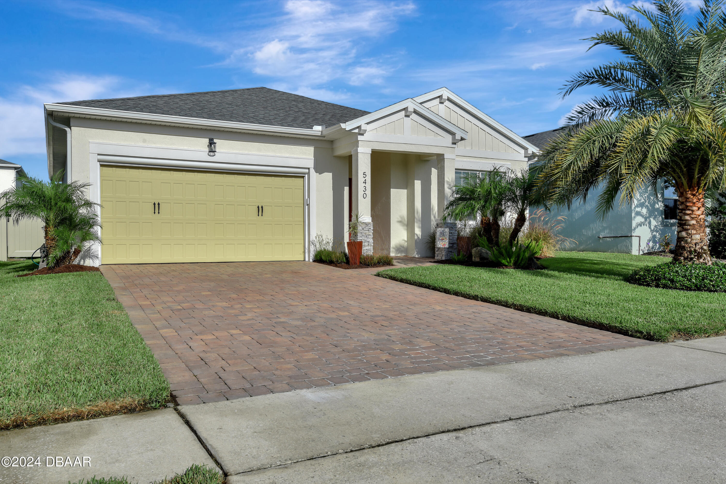 5430 Estero Loop Port Orange, FL 32128 - Photo 45 of 66 a front view of a house with a yard and garage