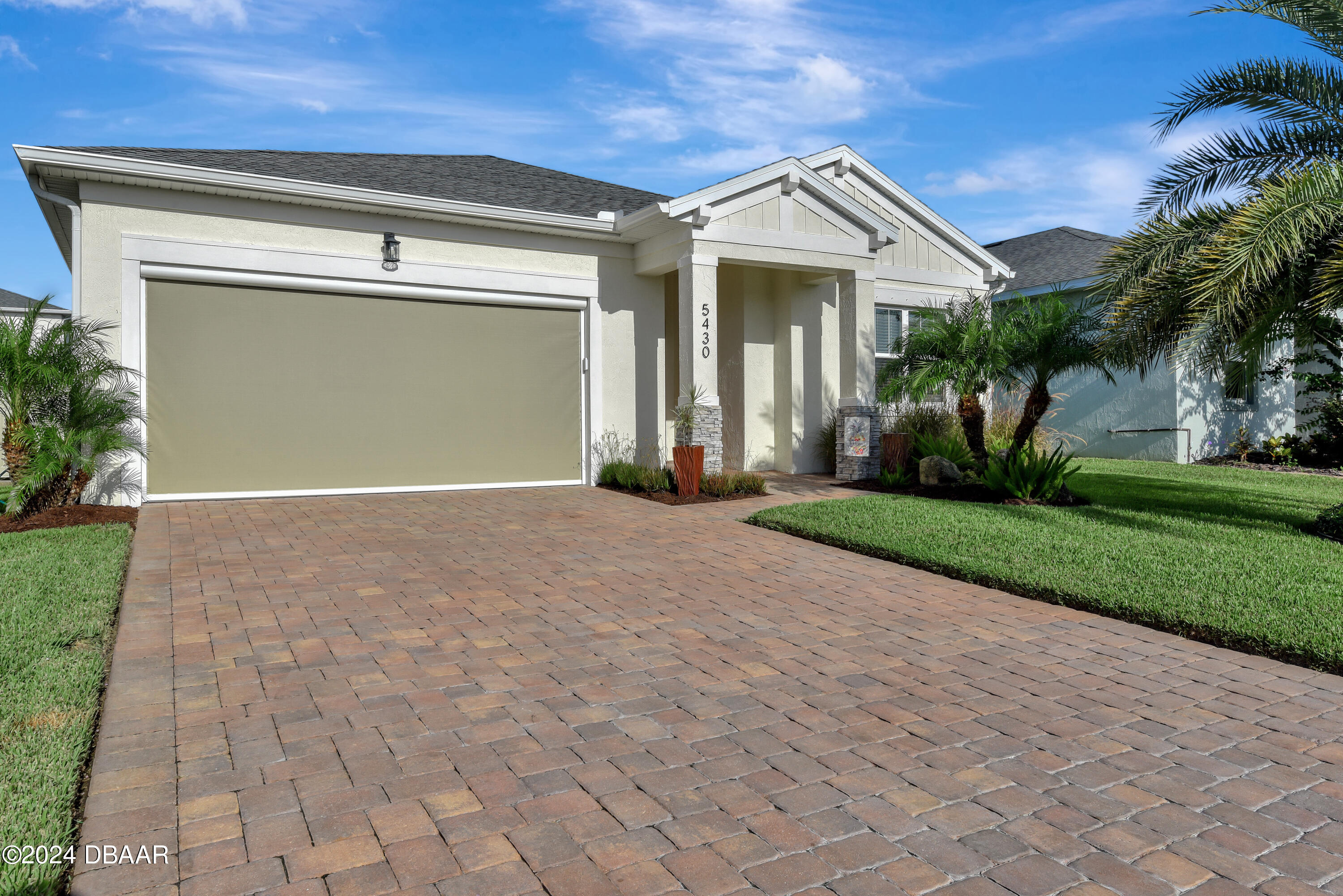 5430 Estero Loop Port Orange, FL 32128 - Photo 50 of 66 a front view of a house with a yard and garage