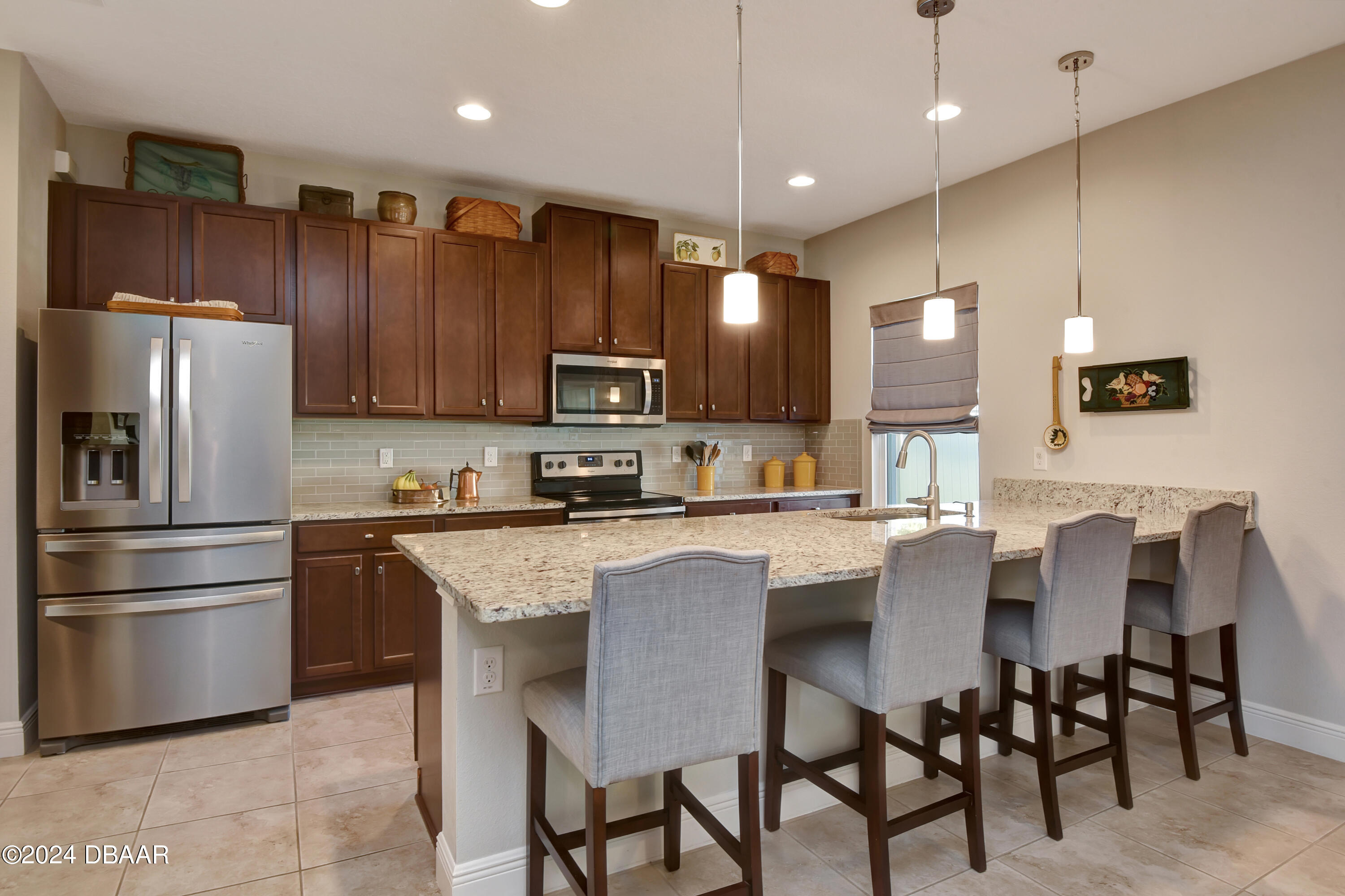 5430 Estero Loop Port Orange, FL 32128 - Photo 10 of 66 a kitchen with stainless steel appliances granite countertop a refrigerator a stove a sink a dining table and chairs