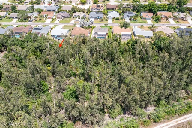 an aerial view of residential building and lake