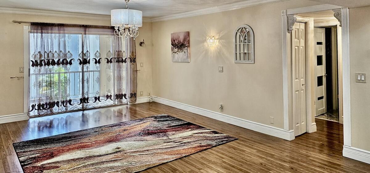 a living room with hardwood floor and a window