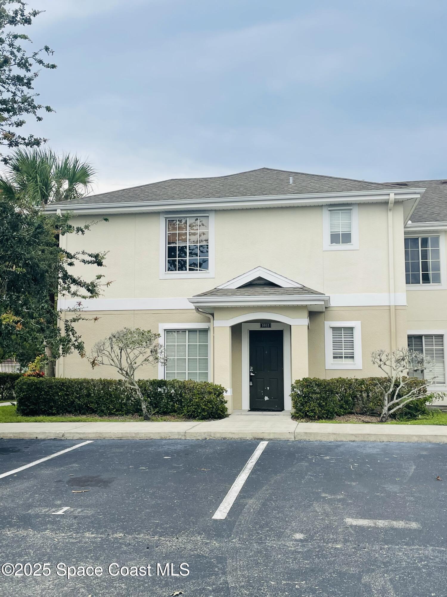 3501 D D'Avinci Way, Unit 1011 Melbourne, FL 32901 - Photo 1 of 19 a front view of a house with a garden