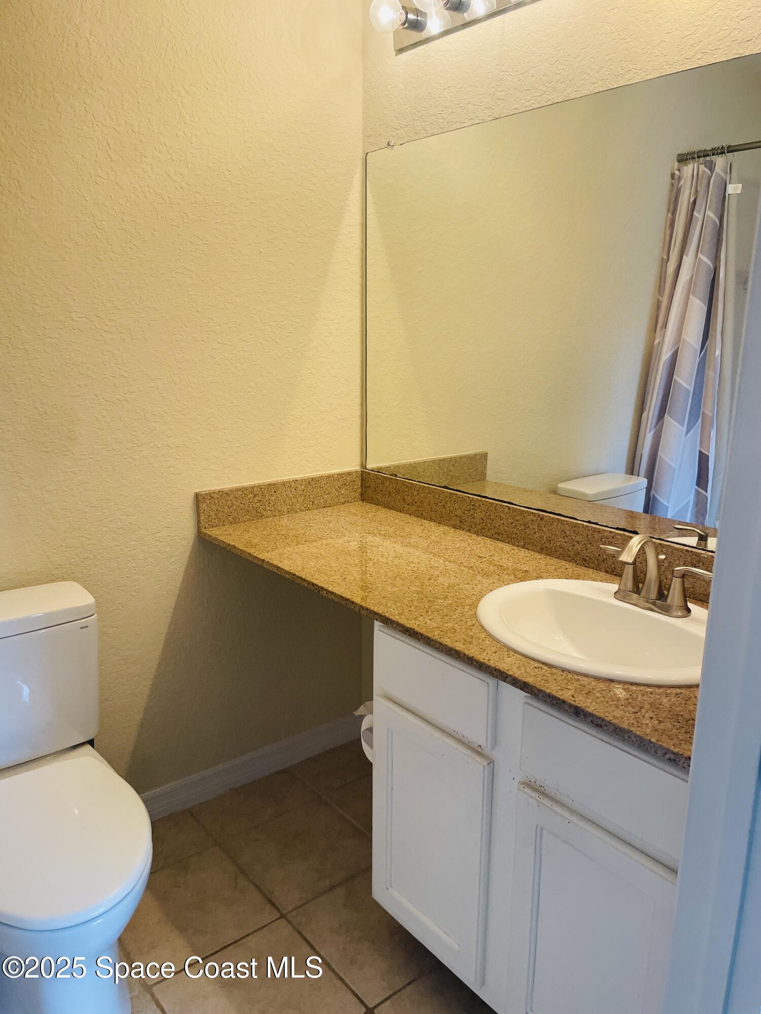 3501 D D'Avinci Way, Unit 1011 Melbourne, FL 32901 - Photo 11 of 19 a bathroom with a sink and a toilet