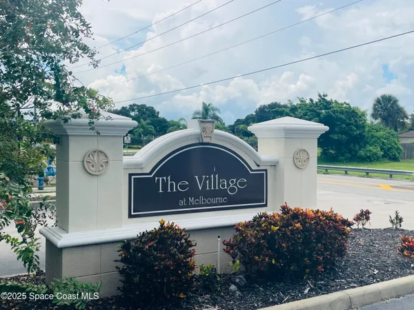 a view of sign board with flower around