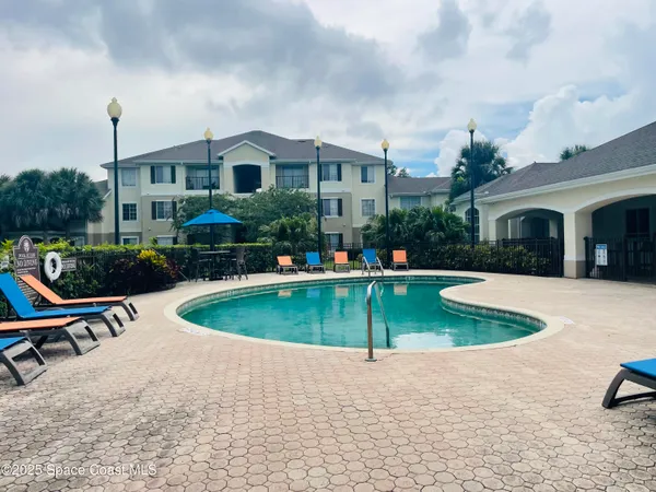 a view of a house with a yard and sitting area