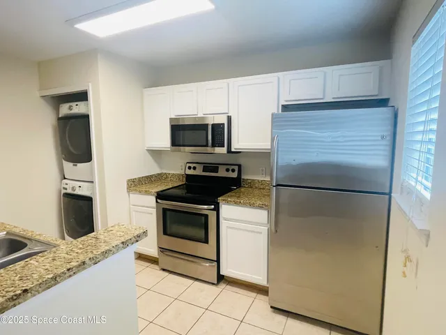 a kitchen with a refrigerator stove and microwave