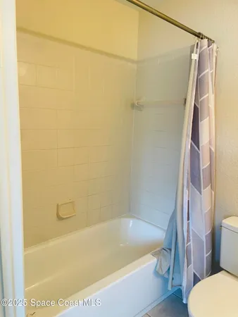 a bath tub sitting next to a white toilet