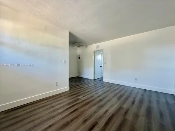 a view of an empty room and wooden floor