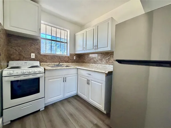 a kitchen with a sink stove and cabinets