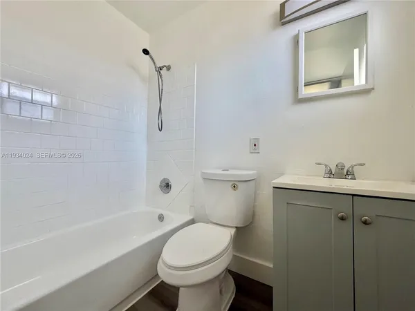 a white toilet sitting next to a bath tub