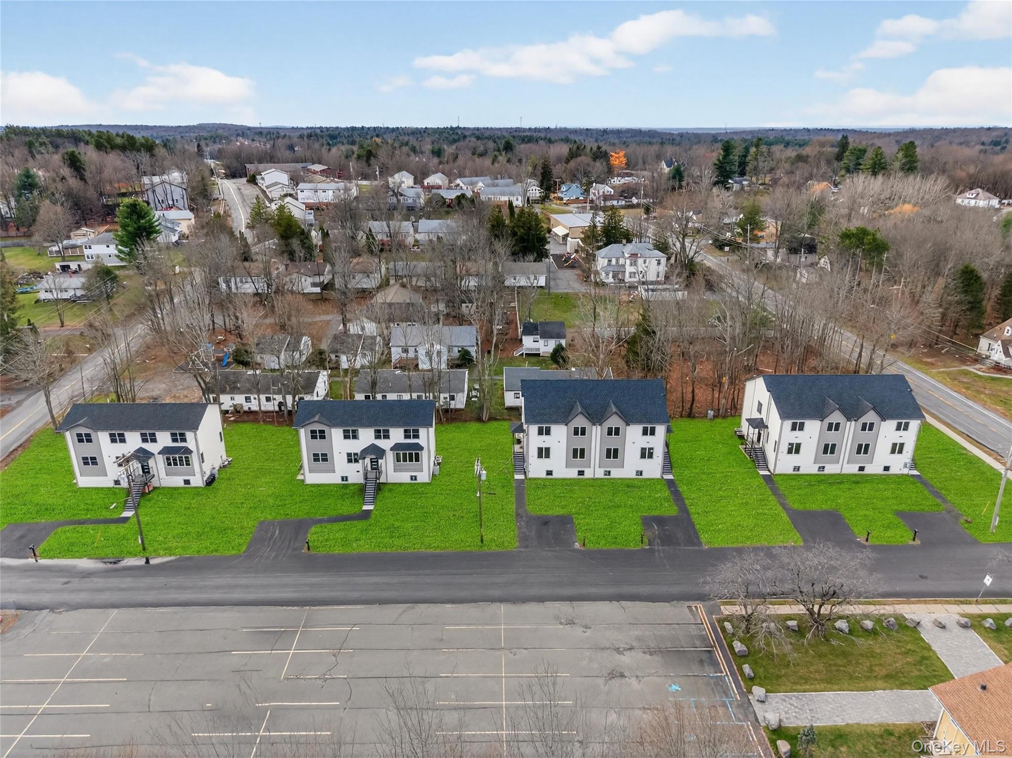 8 East Dillon Road, Unit 201 Monticello, NY 12701 - Photo 3 of 47 a view of a street with cars parked and a park