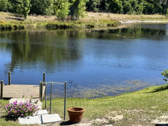 a view of a lake with houses in the back