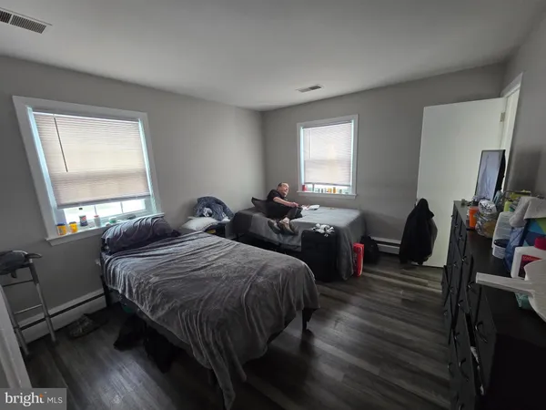 a bedroom with two beds and a flat screen tv