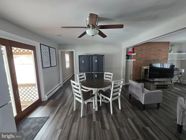 a dining room with furniture window and wooden floor