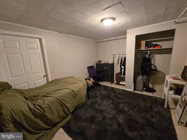 a bedroom with a bed and a chair