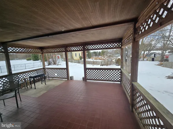 a view of a porch with wooden floor