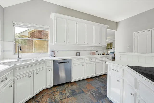 a kitchen with sink cabinets and window