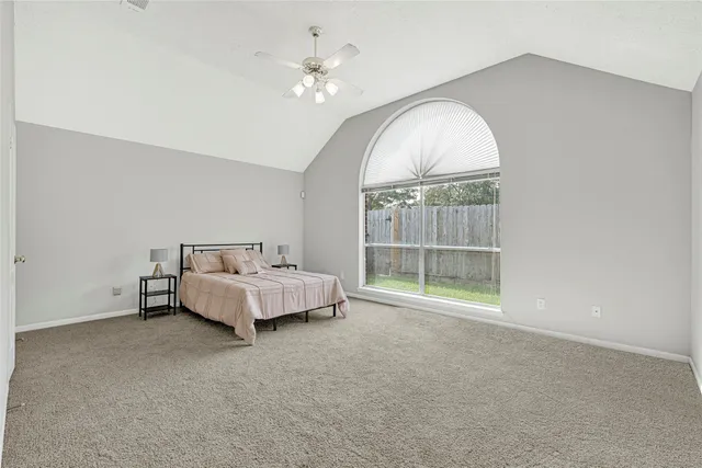 a bedroom with a large bed and a window