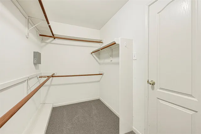 an empty room with windows and ceiling fan