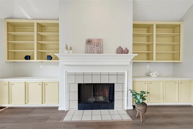 a living room with a fireplace and a window
