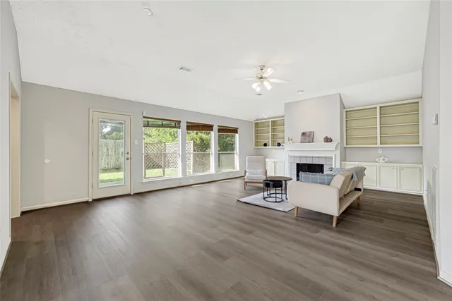a living room with furniture a fireplace and a table