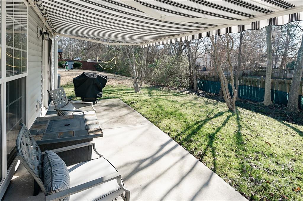 14042 Dingess Road Charlotte, NC 28273 - Photo 21 of 22 a view of a backyard with couches chair and wooden floor