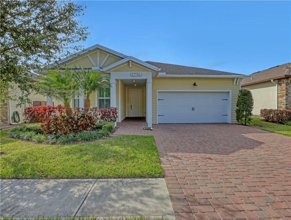 1756 Willows Square Vero Beach, FL 32966 - Photo 1 of 35 a view of a house with a yard and garage