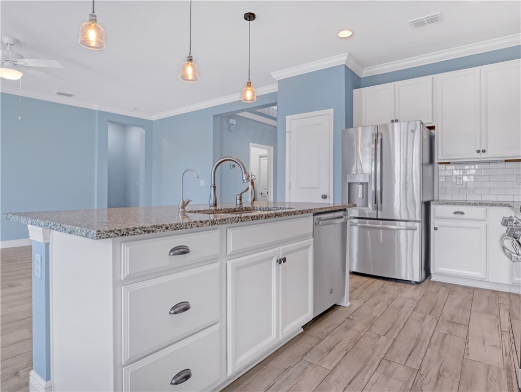 1756 Willows Square Vero Beach, FL 32966 - Photo 13 of 35 a kitchen with stainless steel appliances a sink cabinets and wooden floor