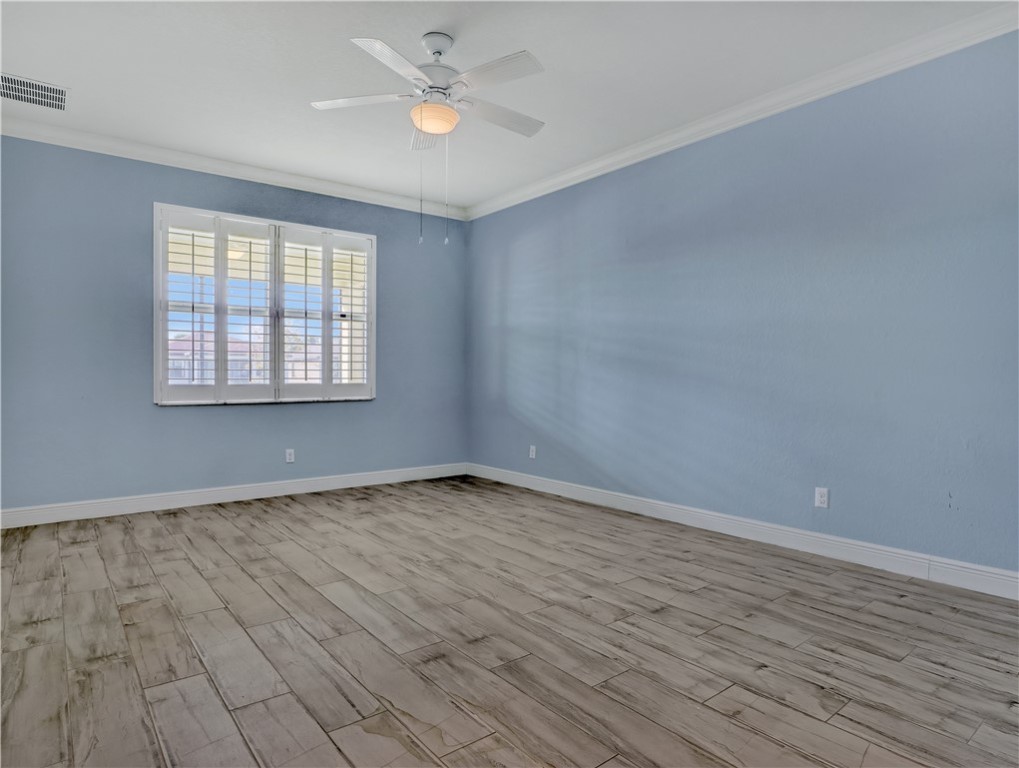 1756 Willows Square Vero Beach, FL 32966 - Photo 17 of 35 an empty room with wooden floor and windows