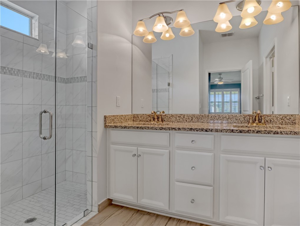 1756 Willows Square Vero Beach, FL 32966 - Photo 22 of 35 a bathroom with a granite countertop sink a large mirror and vanity