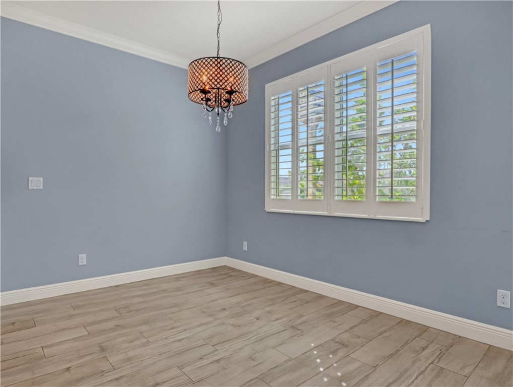 1756 Willows Square Vero Beach, FL 32966 - Photo 9 of 35 a view of an empty room with wooden floor and a window