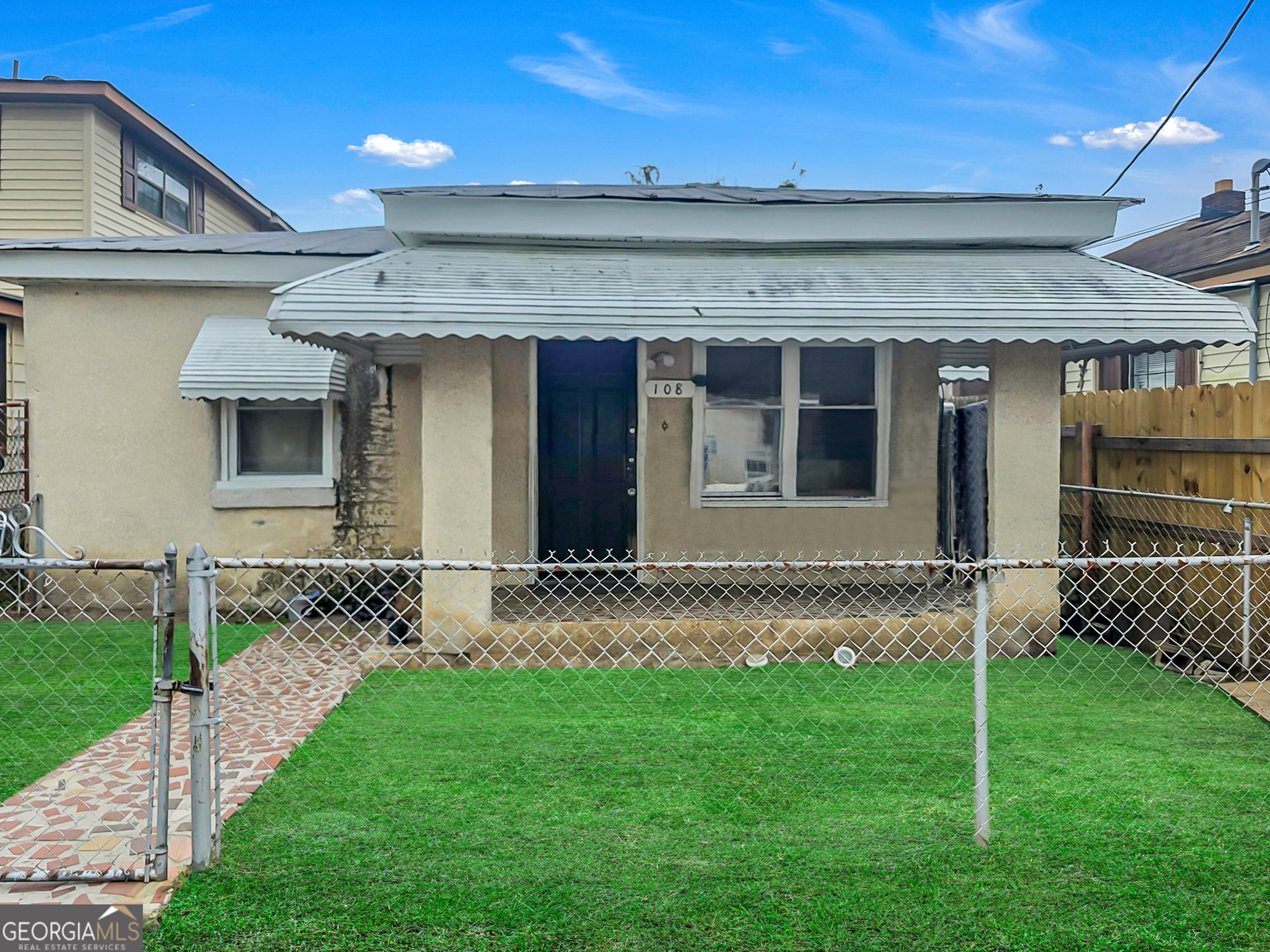 a front view of a house with a garden