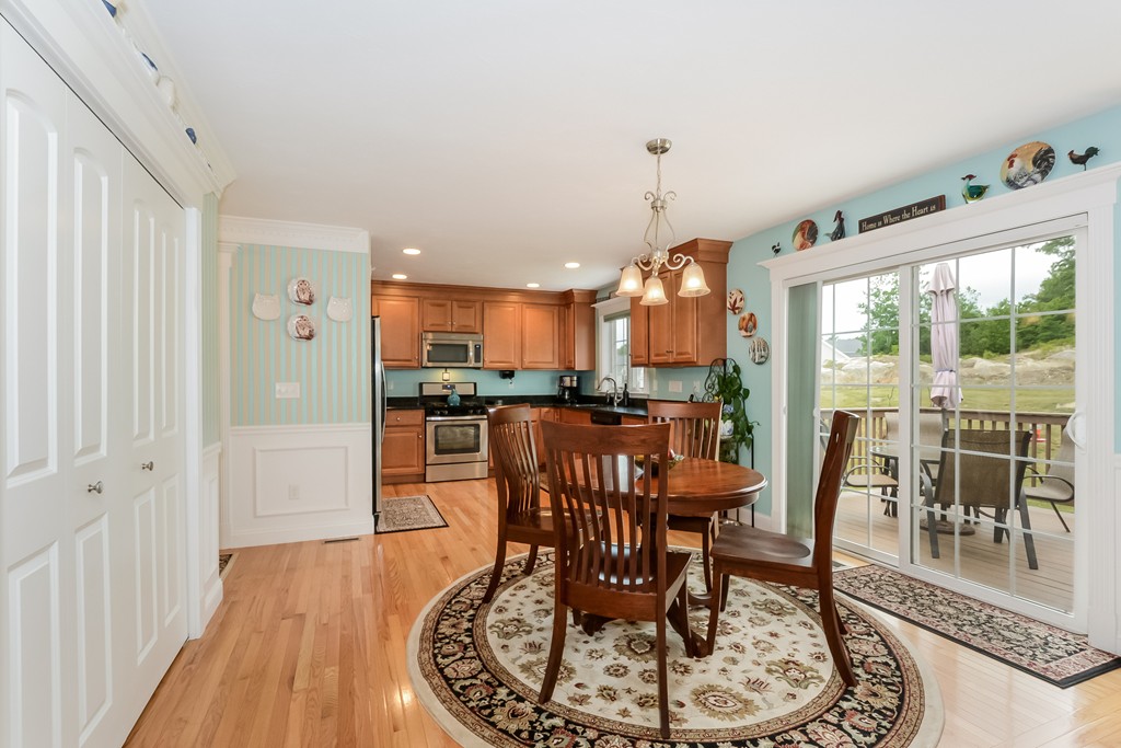 124 Quarry Road, Unit 124 Northbridge, MA 01588 - Photo 8 of 30 a dining room with furniture a chandelier and wooden floor