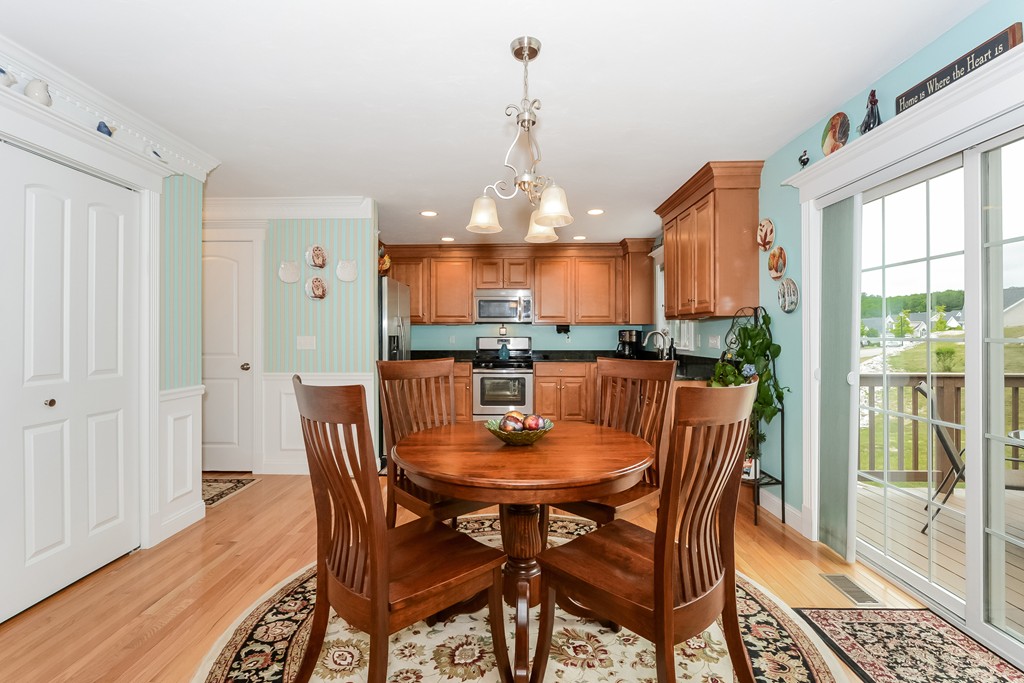 124 Quarry Road, Unit 124 Northbridge, MA 01588 - Photo 9 of 30 a dining room with furniture a chandelier and wooden floor